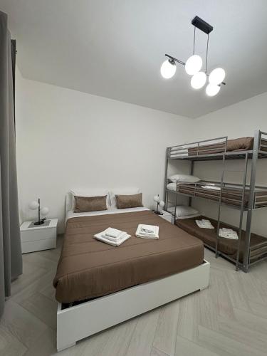 a bedroom with a bed and two bunk beds at OLYMPO HOUSE senza balcone in Agrigento