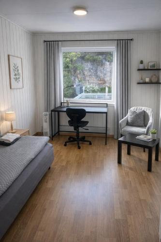 a bedroom with a bed and a desk and a chair at Kristiansund Airport Motell in Kristiansund