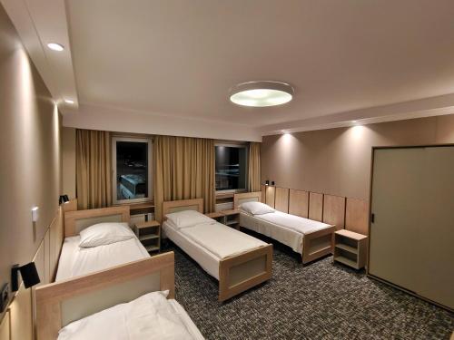 a hospital room with two beds and a chalkboard at Pensione Antonio - Klimatyzowane Pokoje, Centrum Słupska, Spokojny Hotel in Słupsk