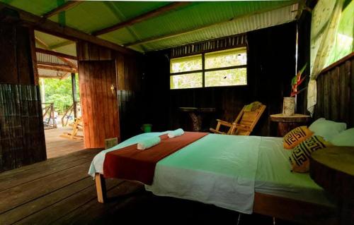 a bedroom with a large bed in a house at Panguana Lodge all included in Iquitos