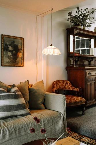 a living room with a couch and a chair at Ateliers Den in Beechworth