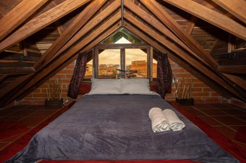 a large bed in a room with a window at Hotel Spa Bliss Guatape in Guatapé