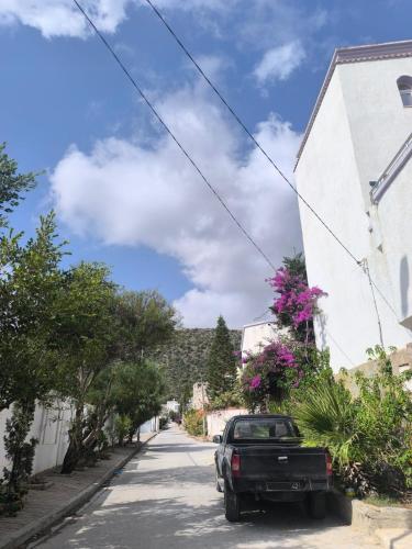 a truck parked on a street next to a building at Bizerte Tunisia cozy studio in Bizerte