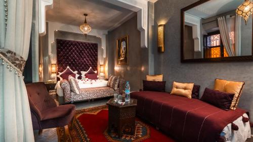 a living room with a couch and a bed at Riad Sultan Suleiman & Spa in Marrakesh