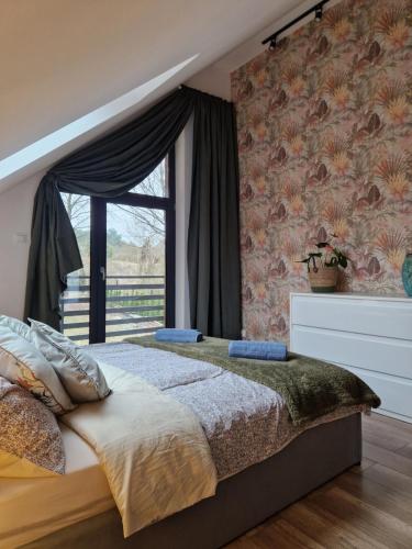 a bedroom with a large bed and a window at Villa OLIVIA Ferienwohnung Misdroy Insel Ostsee in Wicko