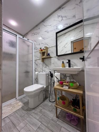 a bathroom with a toilet and a shower and a sink at Dar Diamante Azul in Chefchaouen