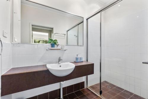 a bathroom with a sink and a mirror at Baden 74 Rainbow Shores in Rainbow Beach