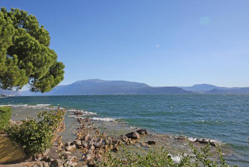 a group of rocks on the shore of a body of water at Villa Elena in Manerba del Garda