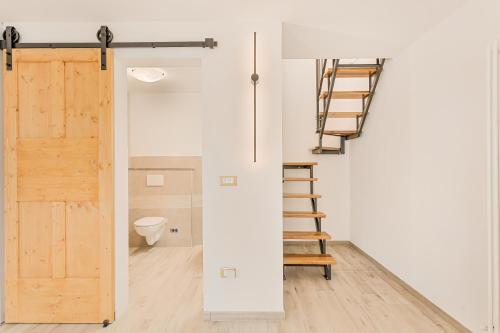 a room with a staircase and a toilet and a door at La Casetta in Carafà in Aulla