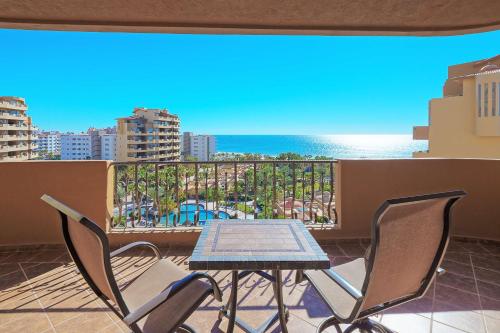a table and chairs on a balcony with a view of the ocean at Bella Sirena Beachfront Resort Condo D603 in Puerto Peñasco