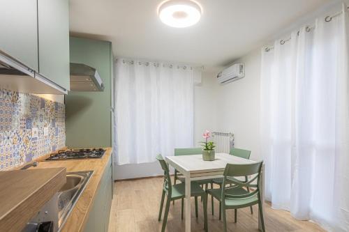 a kitchen with a table and chairs in a kitchen at Sara Home Flo in Florence