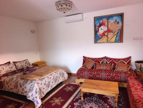 a living room with a bed and a couch at Abla room in Azilal