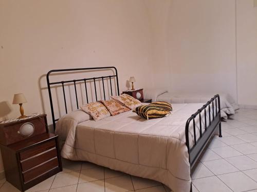 a bedroom with a bed and a night stand at Casa in centro a Giarre in Giarre