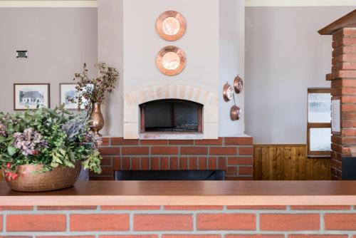 a brick fireplace in a dining room with a brick table at Penzion Janová in Ostrava