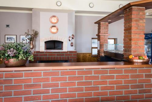 a brick wall in a room with a fireplace at Penzion Janová in Ostrava