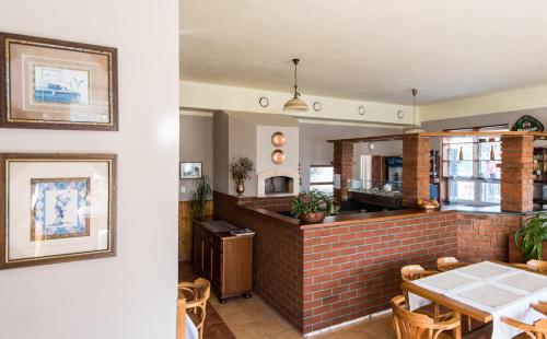 a restaurant with a brick counter and a table at Penzion Janová in Ostrava