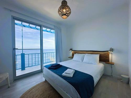 a bedroom with a bed and a large window at Eirinhas Bela Vista RAAL 2909 in Maia