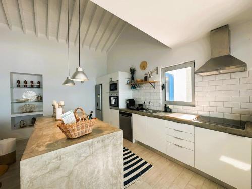 a kitchen with white cabinets and a counter top at Eirinhas Bela Vista RAAL 2909 in Maia