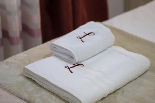 two towels sitting on top of a table at Lana's House in Berat