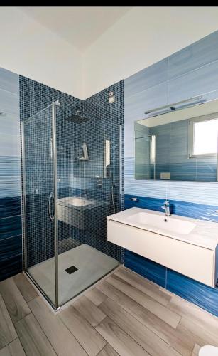 a bathroom with a shower and a sink and a tub at Hotel Paladini in Porto Cesareo
