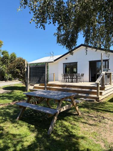 a picnic table in front of a house at Lockwood on Cologne in Martinborough