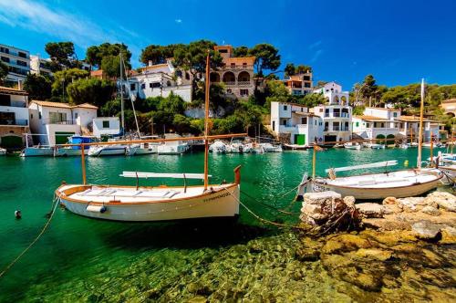 two boats docked in the water in a harbor at Residencia Santiago Mallorca in Cala Figuera