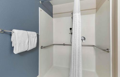 a shower with a white shower curtain in a bathroom at Extended Stay America Suites - Houston - Galleria in Houston