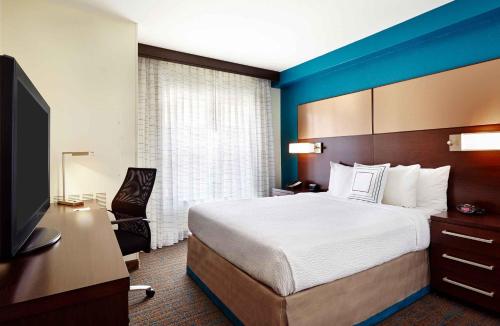 a hotel room with a bed and a television at Extended Stay America Suites - Houston - Galleria in Houston