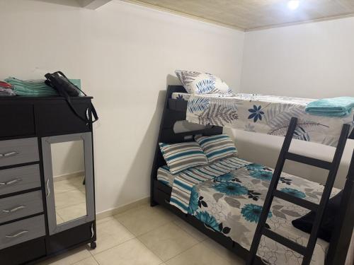 a dorm room with a bunk bed and a desk at La Estancia Tolimense in Ibagué