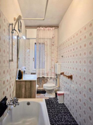 a bathroom with a tub and a toilet and a sink at Altobello Venice Apartment in Mestre