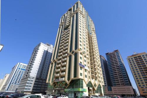 a tall building in the middle of a city at ALEX Hostel C2602 - Bed in Shared Room for Males in Sharjah