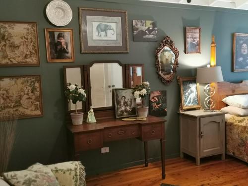 a bedroom with a bed and a table with a mirror at Wyndover Mountain Retreat in Beechmont