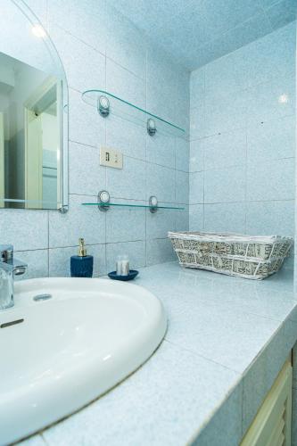 a white bathroom with a sink and a mirror at Relax Between Cinque Terre and Portofino in Moneglia