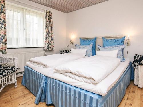 two beds in a room with blue and white at Holiday home in Marstal in Brovst