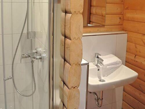 a bathroom with a sink and a shower at Bernsteinsee Home and Ferien Forest Chalet in Sassenburg