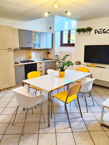a kitchen and dining room with a table and chairs at Old Town Apartment with Terrace - Live Love Lake in Peschiera del Garda