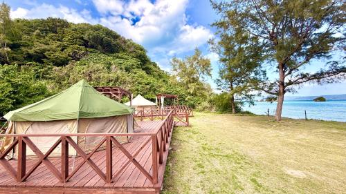 a group of tents on a fence near the water at Yagaji Beach(屋我地ビーチ) in Nago