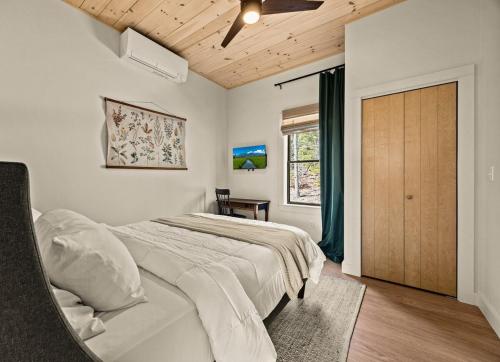 a bedroom with a bed and a wooden ceiling at Villa Acadia with Mountain Views in Bar Harbor