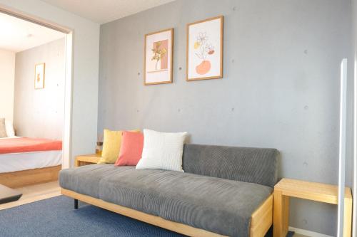 a living room with a couch and a bed at Haneda apt area 15min by car Lovely New 1 bedroom 西糀谷501 in Tokyo