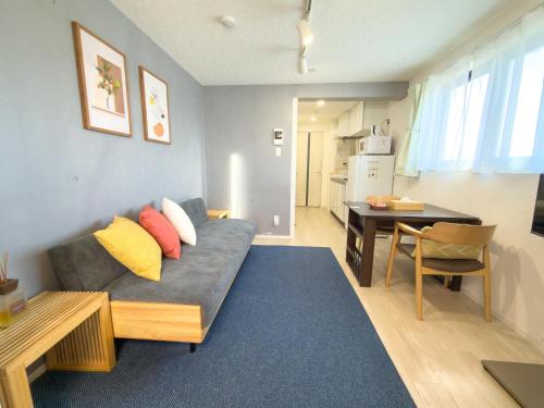 a living room with a couch and a table at Haneda apt area 15min by car Lovely New 1 bedroom 西糀谷501 in Tokyo