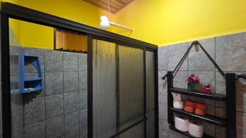a shower stall in a bathroom with a yellow wall at Rústicas Dani & Fam in Fortuna