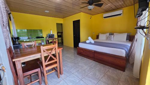 a bedroom with a bed and a table and a desk at Rústicas Dani & Fam in Fortuna