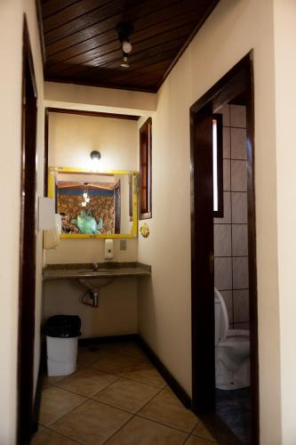 a bathroom with a sink and a mirror in a room at Bella Pousada in Abraão