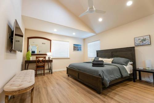 a bedroom with a bed and a table and a mirror at Mission Casa Del Mar in San Diego