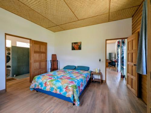 a bedroom with a bed with a colorful bedspread at Mana Henua Lodge in Nuku Hiva