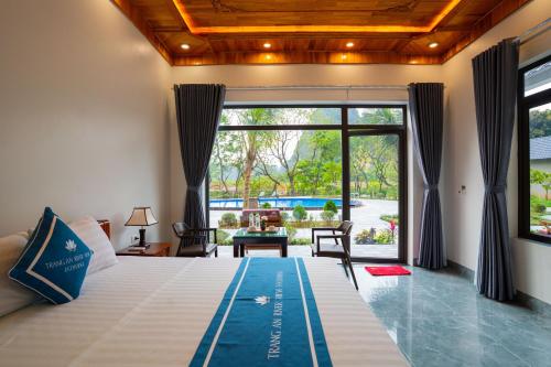 a bedroom with a bed and a large window at Trang An River View Ecolodge in Ninh Binh