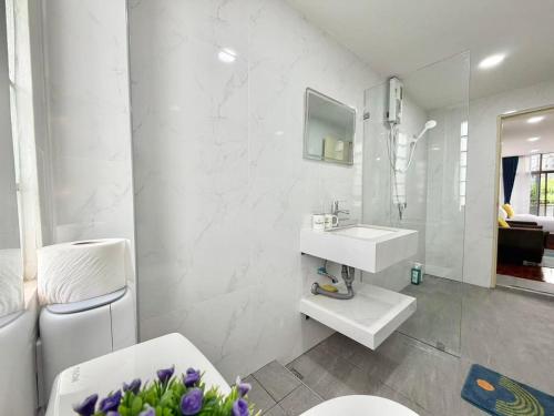 a white bathroom with a sink and a toilet at S Hostel sukhumvit48 Near Phrakanong BTS 2001 in Bangkok