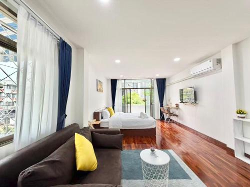 a living room with a couch and a bed at S Hostel sukhumvit48 Near Phrakanong BTS 2001 in Bangkok