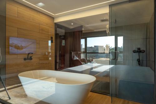 a bathroom with a tub and a sink at Quiet Dreams - Serviced Apartments King abdul Aziz Street Branch in Jeddah