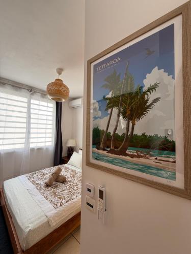 a bedroom with a picture on the wall at Ora Stay in Papeete